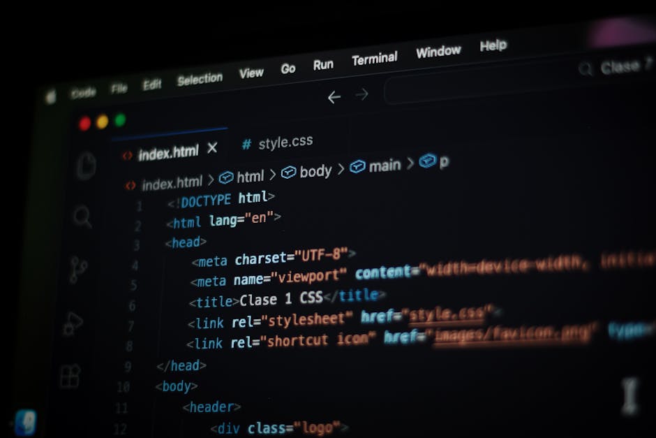 A close-up digital photograph of a computer screen displaying lines of HTML code within a text editor interface. The code includes tags such as <DOCTYPE html>, <html>, <head>, <meta>, and <title>, wit